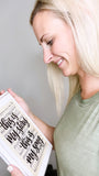 Model looking at Blessed Assurance Hymn Sign made from wood with the hand lettered lyrics "This is my story, This is my Song".