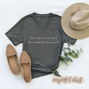 Flatlay Christian shirt that says "I have a great need for Christ | I have a great Christ for my need" in hand lettered script. 